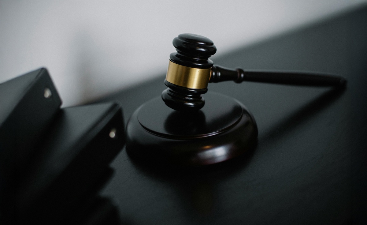 A judge's gavel on a dark desk, representing the legal controversy involving Judge Padman Surasena and Christianity.